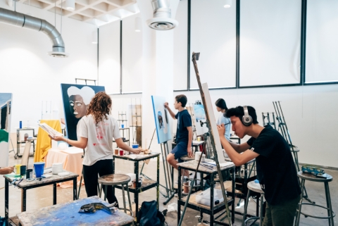 Students in a studio working at easels