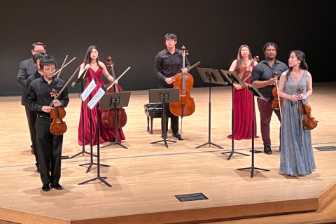 Chamber music group addressing audience