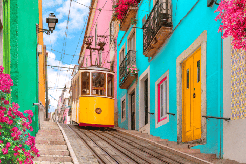 Image of a colorful European street with trolly running through it