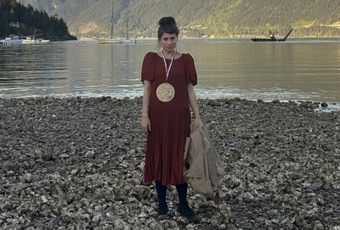 Person in red dress wearing medal